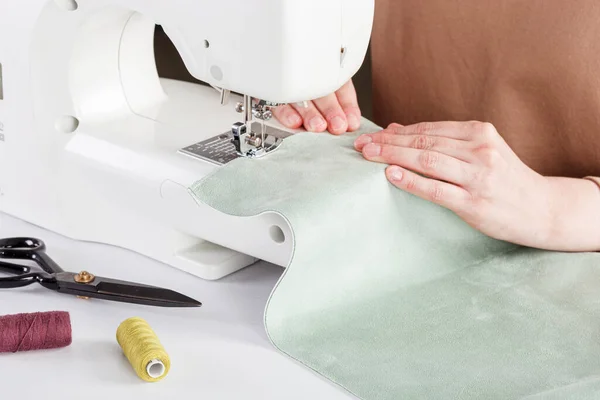 Sewing machine, stitching fabrics, needle in a round plan close up
