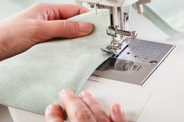 Sewing machine, stitching fabrics, needle in a round plan close up