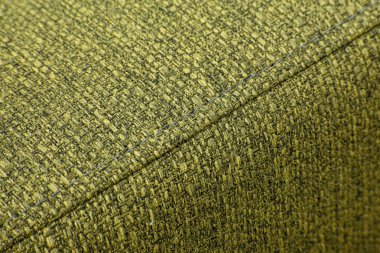 Dokulu yeşil mobilya kumaşı, yakın plan dikişli.