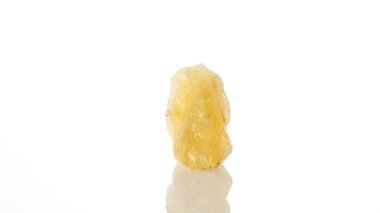 mineral stone citrine rotates in a circle on a white background close-up clipart