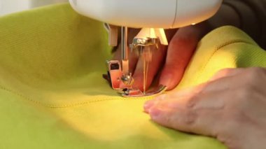 Dikiş makinesinin kumaş dikme işlemi, dikiş makinesi iğnesi yakın çekim hareketi.