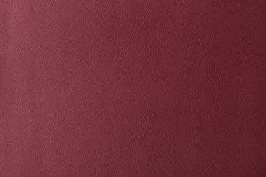 Texture of genuine leather, artificial leatherette red background close-up