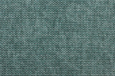 Elbise dikmek için fabrika kumaşının yeşil dokusu, mobilyaların yakın çekimi