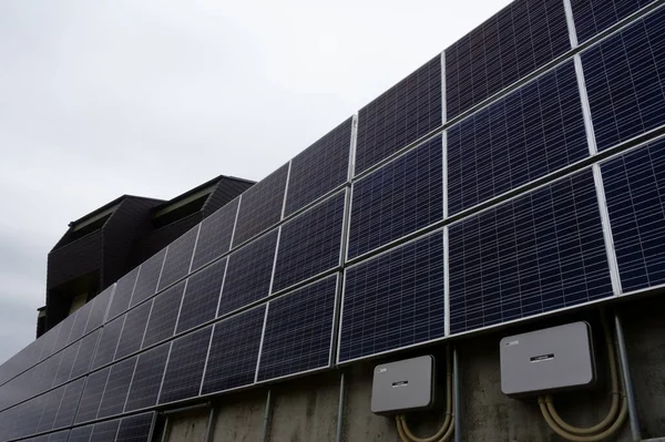 stock image Photovoltaic power generation system equipment panel plate wall attached to a residential building