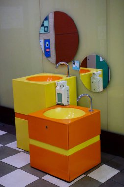A fully equipped multi-purpose toilet in a modern public toilet