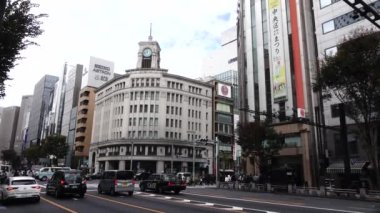 November 07, 2022: Tokyo, Japan, Ginza luxury shopping mall district, Harumi Dori at the landmark Wako clock tower with 4-chome crossing