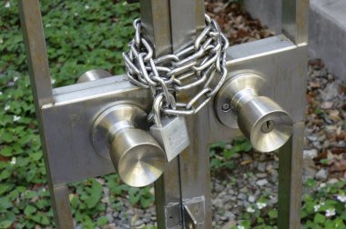 Heavy duty metal chain lock attached to gate door
