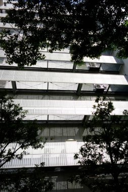 Şehirde modern bir bina, parlak ama göz kamaştırıcı gümüş bir balkon.