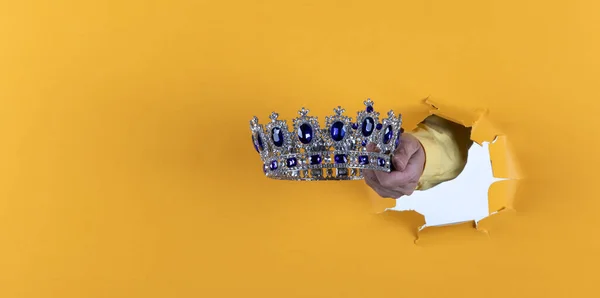 Crown Hand Yellow Background — Zdjęcie stockowe
