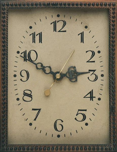 old cardboard clock face with arrows