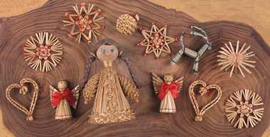 christmas straw toys on wooden background