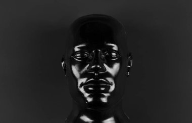 black mannequin head isolated on black background