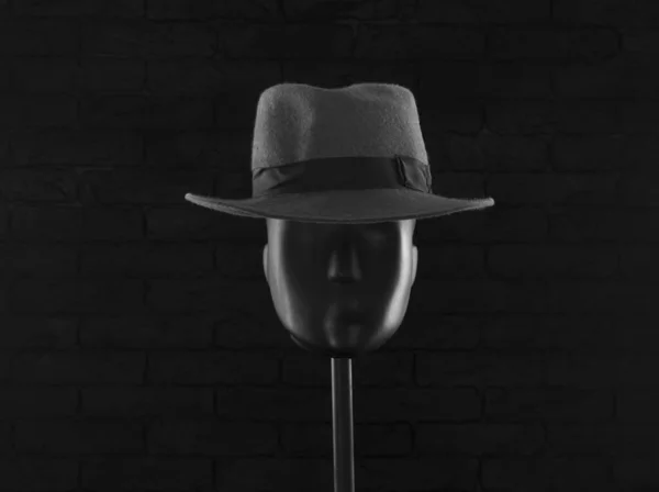classic man hat on a mannequin on a black background