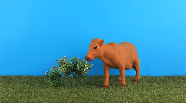 toy cow on the grass