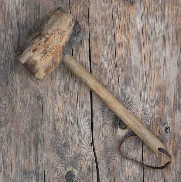 ancient wooden hammer on wooden background