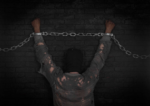 hands with prison chains, black brick wall