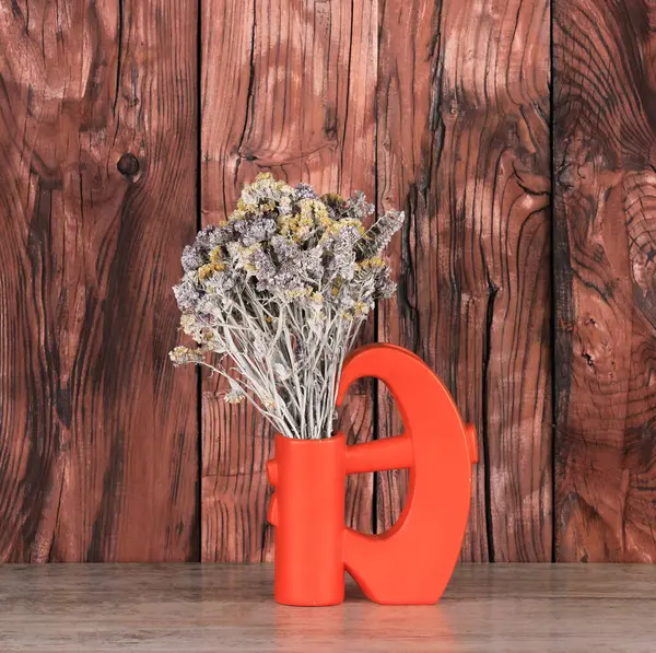 abstract vase with flowers on a wooden table