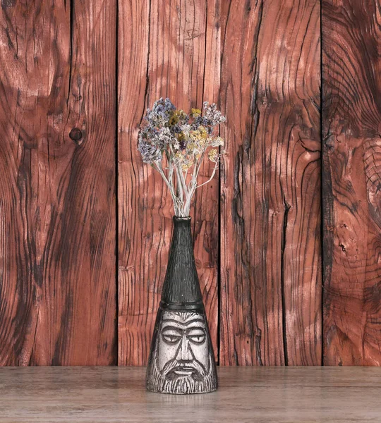 abstract vase with flowers on a wooden table