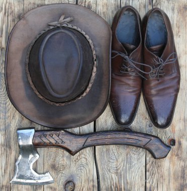 Kovboy şapkası ve baltası eski ahşap arka planda