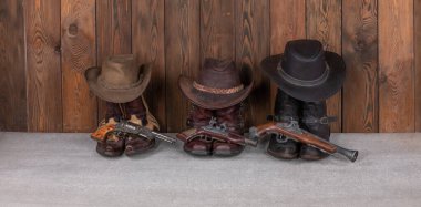 cowboy hat, boots and gun on a wooden floor clipart