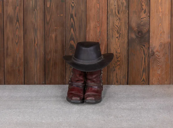 cowboy hat and boots on wooden floor