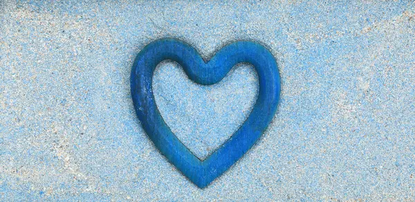 blue heart on blue wooden background