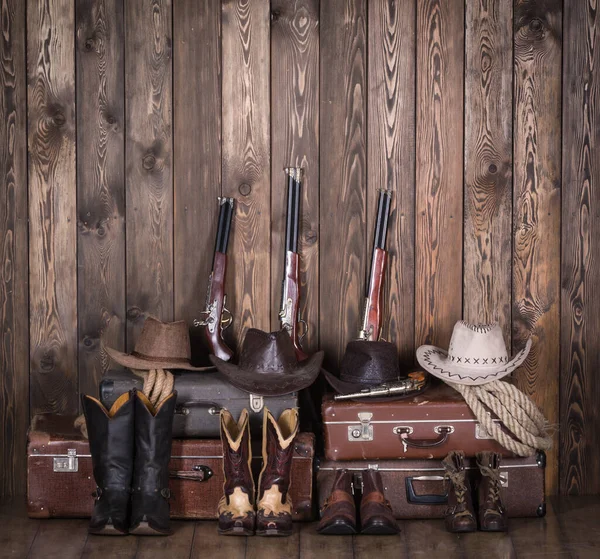 stock image Cowboy hat, boots and weapons on the background of the old barn.Wild west, cowboy,Vintage