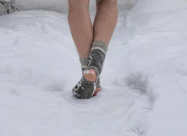 feet in socks in the snow