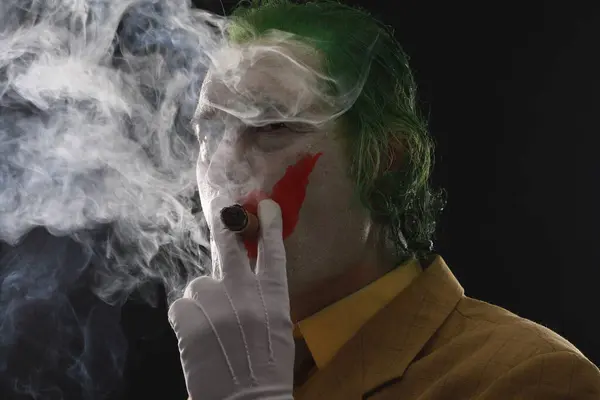 men in joker mask with cigar