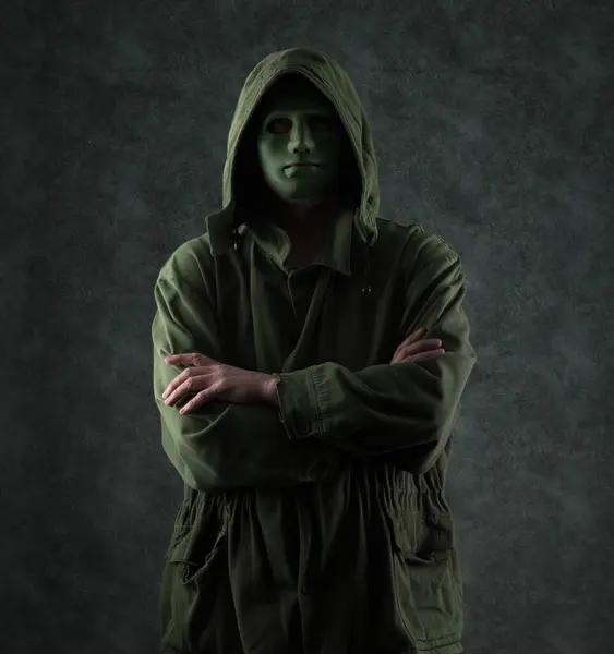 portrait of a strange man in a green mask