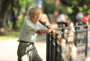 Yaşlı adam yazın dışarıda dinleniyor.