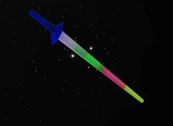 toy laser sword on a black background