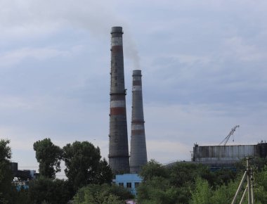 Çevredeki endüstriyel bacalardan duman çıkıyor.