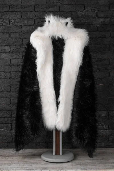 black fur coat on a hanger