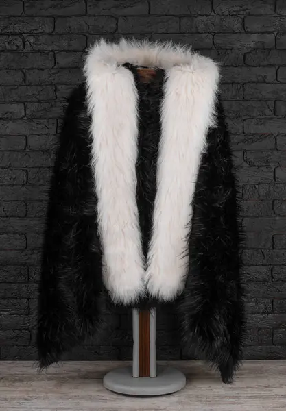 black fur coat on a hanger