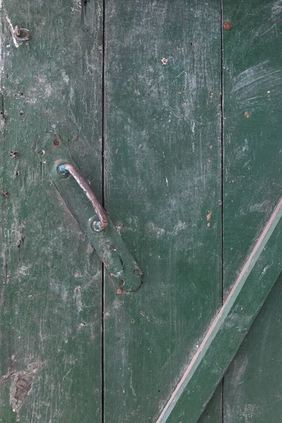 old wooden green door with door handle