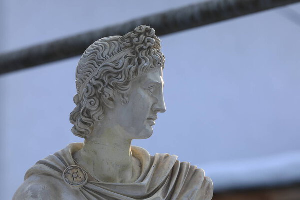 sculpture of the head of Apollo outdoors