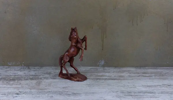 wooden horse figurine on a wooden table