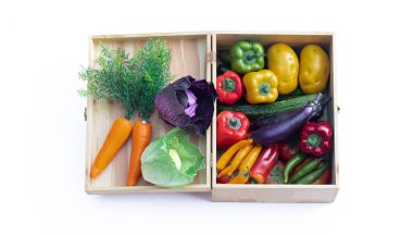 artificial vegetables in basket isolated on white background