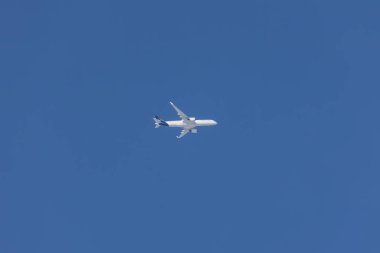 Germany, Dieen 06.01.2023, Lufthansa passenger airplane Airbus A350 moves driftlessly in blue sky over Ammersee lake.