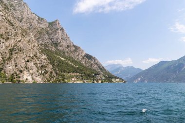 Wooded mountain top and rock wall on the northern shore of Lake Garda in Italy