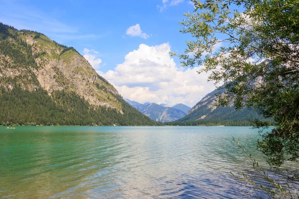 stock image View over the lake Heiterwanger See near Heiterwang in Austria on a sunny day with blue sky and cumulus clouds.