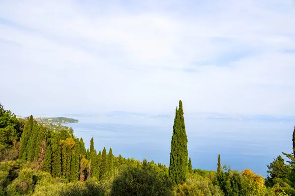 View from the former villa of Empress Sissi Achilleion over forests of cypress and olive trees to the city of Corfu