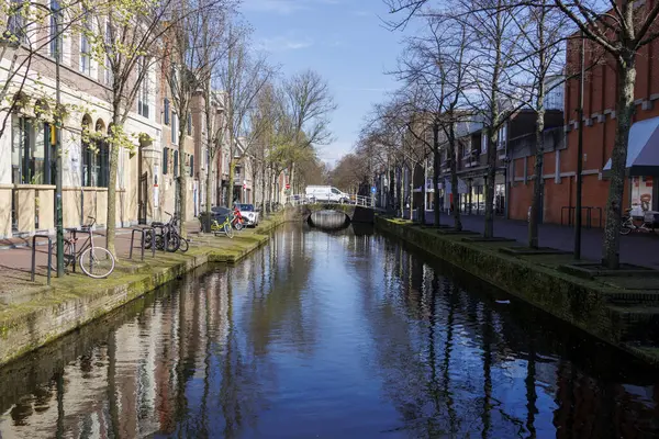 stock image Spring in a street with residential houses on a city canal called Gracht in the Netherlands, Delft, 25.3.2024