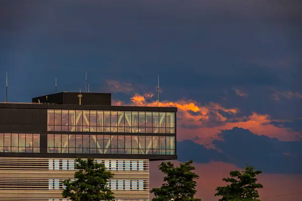 stock image Modern office building in the Innovation Park in Augsburg under dark storm clouds in the evening