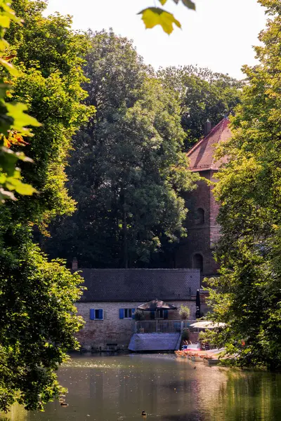 stock image View across the outer city moat to the new construction of the traditional boat trip at the Oblatterwall a boat rental and restaurant in Germany, Augsburg, 18.7.2024