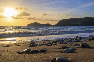 Sunset over the beach of Agios Georgios on the island of Corfu clipart