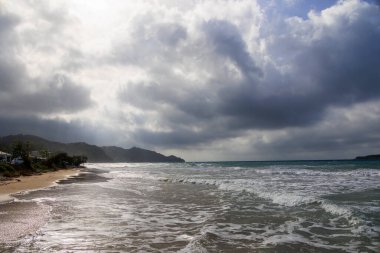 Coast of the island of Corfu near the town of Arillas under cloudy skies and heavy seas clipart