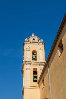 Mavi gökyüzü altında parlak Latince çan kulesi, Fransa, Korsika, Cargse, 15 Haziran 2025