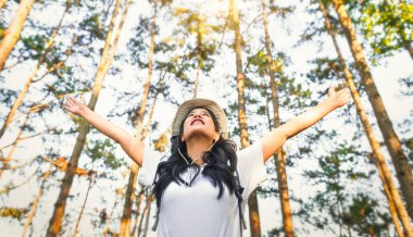 travel hiker walking in natural forest happy with arm up